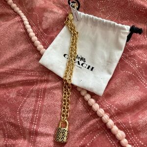 Gold chunky Coach necklace with a lock